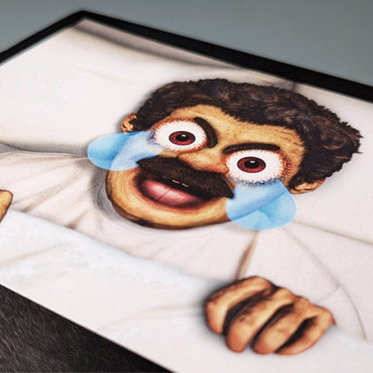 A close-up photo of a postcard featuring the AAAaaa Guy from Kiszkiloszki animation. The man is lying in his bed, screaming in a mix of anger and sadness, with comic-like tears streaming from his eyes.